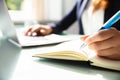 Close-up Of A Businesswoman`s Hand Writing Note In Diary