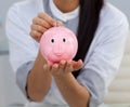 Close-up of a businesswoman saving money