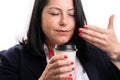 Close-up of businesswoman smelling coffee aroma from paper cup