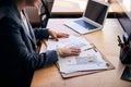 Female architect sitting at the table with laptop and papers Royalty Free Stock Photo