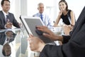 Close Up Of Businesswoman Using Tablet Computer During Board Meeting Around Glass Table Royalty Free Stock Photo