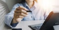 close up of businesswoman working with smart phone and laptop and digital tablet computer in modern office with virtual icon Royalty Free Stock Photo