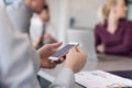 Close up of busineswoman hands using smart phone on meeting Royalty Free Stock Photo