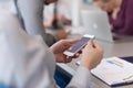 Close up of busineswoman hands using smart phone on meeting Royalty Free Stock Photo