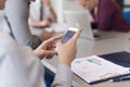 Close up of busineswoman hands using smart phone on meeting Royalty Free Stock Photo