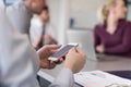 Close up of busineswoman hands using smart phone on meeting Royalty Free Stock Photo