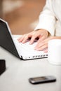 Close-up of a busy businesswoman using her laptop