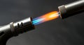 Close-up of a butane torch flame igniting, with blue and orange hues Royalty Free Stock Photo