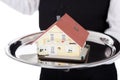 Close-up of a butler with model of a house Royalty Free Stock Photo