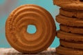 Close up of butter cookies/biscuits on wooden board with teal green rustic background Royalty Free Stock Photo