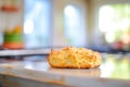 close-up of buttermilk biscuit on wire rack, kitchen table