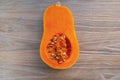 Close up of a butternut squash on a wooden table.