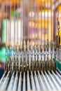 Close Up Cable Sling of Weaving Machine and Thai traditional Silk. Weaving loom for homemade Silk textile. Royalty Free Stock Photo