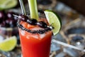 A close up of a Caesar cocktail garnished with black olives and black rock salt. Royalty Free Stock Photo