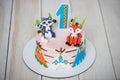 Close up of cake from pastry chef for birthday 1 year old baby. Children`s cake is decorated with animal figures, wigwam and