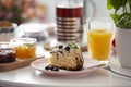 Close-up on cake on plate on a table with orange juice during br Royalty Free Stock Photo