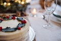 A close-up of cake on table set for dinner meal at Christmas time. Royalty Free Stock Photo