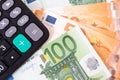 Close-up of calculator on Euro banknotes. Euro money bills to pay. Finances and budget concept. Royalty Free Stock Photo