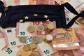 Close-up of a calculator, euro bills and diy facemask, designed as an European Union flag. Royalty Free Stock Photo