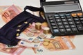 Close-up of a calculator, euro bills and diy facemask, designed as an European Union flag. Royalty Free Stock Photo