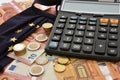 Close-up of a calculator, euro bills and diy facemask, designed as an European Union flag. Royalty Free Stock Photo