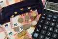 Close-up of a calculator, euro bills and diy facemask, designed as an European Union flag. Royalty Free Stock Photo