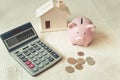 Close-Up of Calculator, Piggy Bank, Money Coin and Housing Model on The Bedroom, Business Banking and Financial Savings Concept Royalty Free Stock Photo