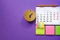 Close up of calendar and alarm clock on the purple  table Royalty Free Stock Photo