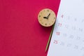 Close up of calendar, clock and pencil on the red table background Royalty Free Stock Photo