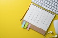 Calendar and computer keyboard on the yellow table background, planning for business meeting or travel planning Royalty Free Stock Photo