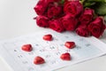 Close up of calendar, heart, candies and red roses Royalty Free Stock Photo