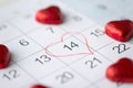 Close up of calendar and heart shaped candies Royalty Free Stock Photo