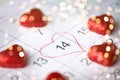 Close up of calendar and heart shaped candies Royalty Free Stock Photo