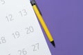 Calendar and pen on the purple table, planning for business meeting or travel planning concept Royalty Free Stock Photo