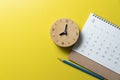 calendar, pencil, alarm clock on the yellow table background, planning for business meeting or travel planning concept Royalty Free Stock Photo