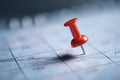 Close-up of calendar with red thumbtack marking important appointment Royalty Free Stock Photo