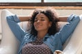 Close up calm African American woman relaxing in cozy chair