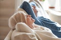 Close up of calm aged couple relaxing on cozy couch