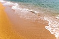 Close-up, calm ocean or sea surf crashing onto a golden sandy beach Royalty Free Stock Photo