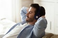Close up calm peaceful man wearing headphones enjoying music Royalty Free Stock Photo