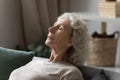 Close up calm peaceful mature woman relaxing with closed eyes