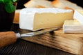 Close up of camembert or brie cheese on wooden cutting board Royalty Free Stock Photo