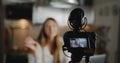 Close-up camera is filming happy young Caucasian travel blogger woman for new vlog video at home kitchen slow motion. Royalty Free Stock Photo