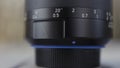 Close up of camera lens. Action. Details of black plastic photo and video new camera body on blurred background. Royalty Free Stock Photo