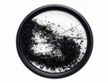 Close up of camera lens filter filled with dark specks and debris on white background Royalty Free Stock Photo