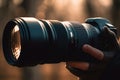 Close-up of a camera with a long focal length lens in the hands of a photographer