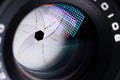 Close-up of a camera mirror lens front lens with aperture and highlights from a light source Royalty Free Stock Photo