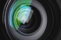 Close-up of a camera mirror lens front lens with aperture and highlights from a light source Royalty Free Stock Photo