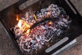 Close up of campfire, fire pit filled with burnt wood, flames. Fire burning, embers glowing Royalty Free Stock Photo
