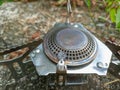 close up of camping gas stove on the grass. portable lightweight stove for hiking, camping, and backpacking.